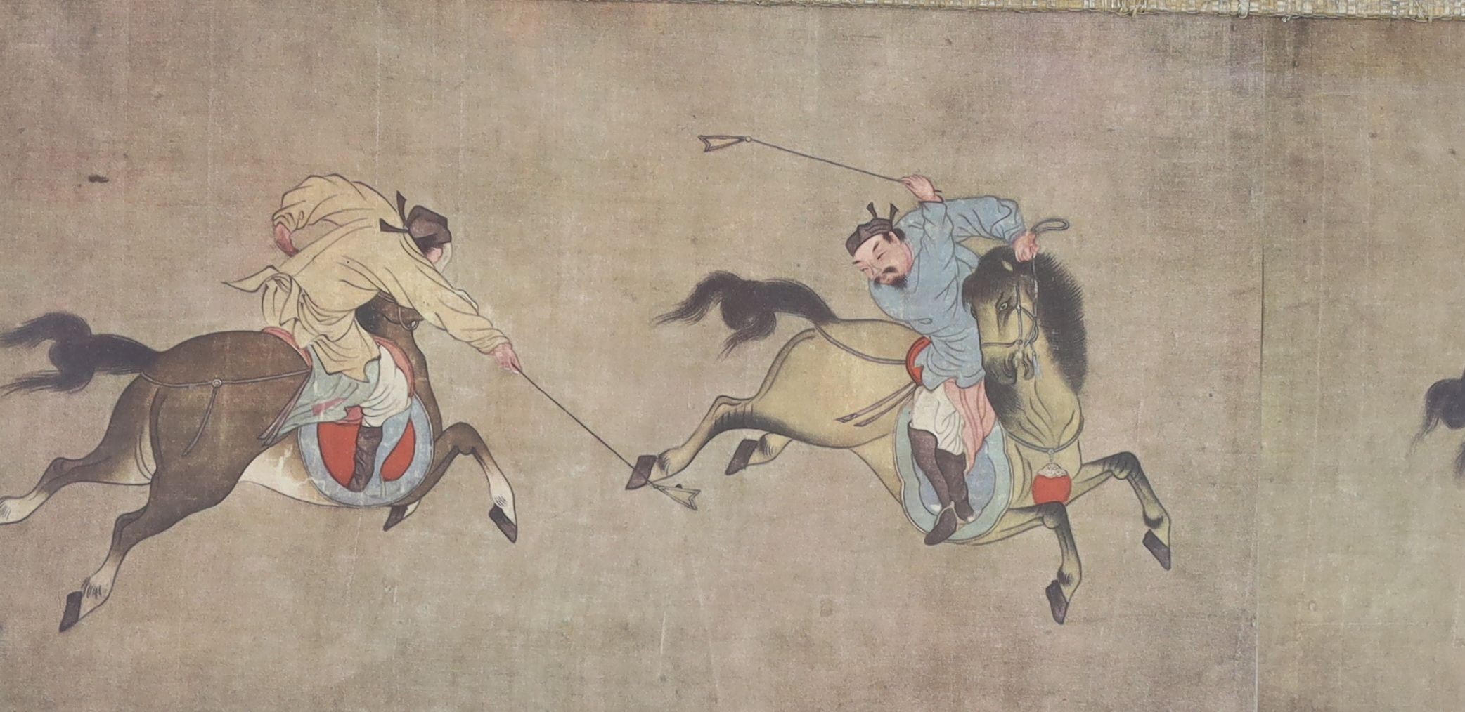 A Chinese silkwork panel of a peacock upon flowering branches, 112 x 35cm and a colour print of Chinese polo players